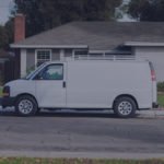 white cargo van parked in front of house
